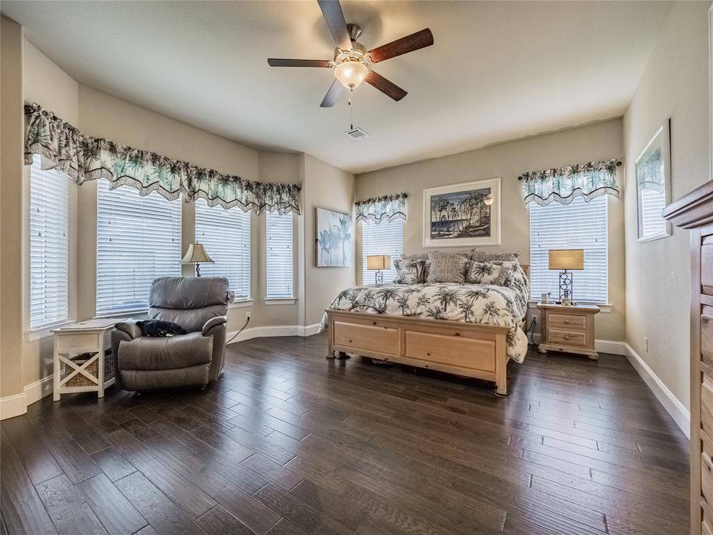 primary bedroom oversized with sitting area and lots of windows for natural light