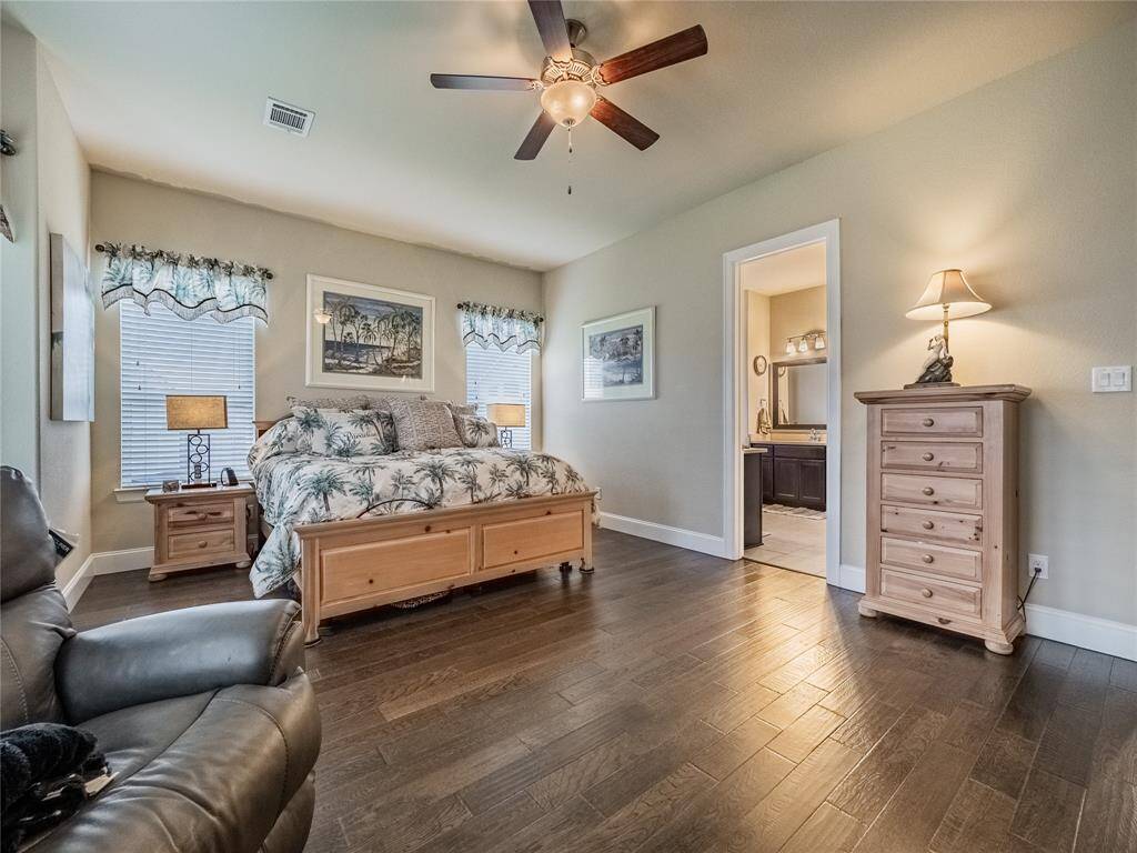 another view of the primary bedroom with beautiful wood floors