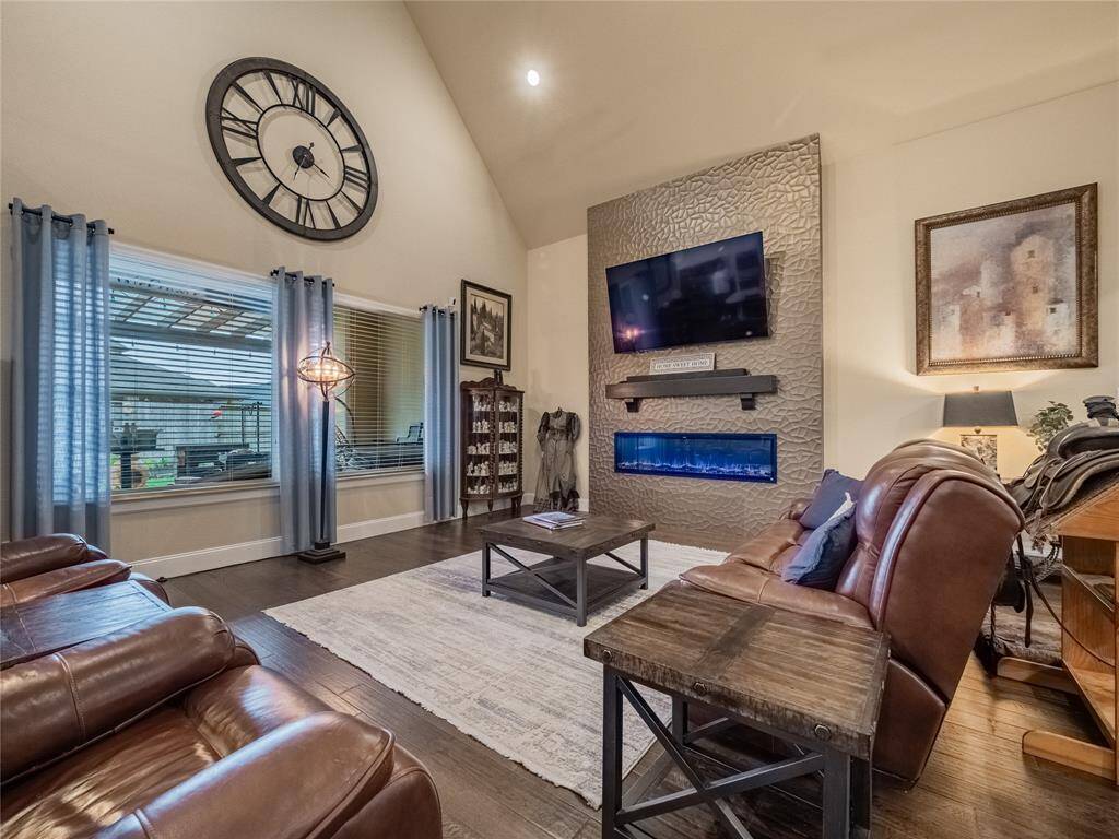 the  family room has oversized double windows over looking the covered patio the firewall is an upgrade fireplace is electric and remote controlled