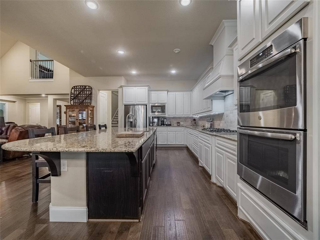 kitchen is open with the oversized island room for 4 barstools plenty of cabinet space stainless steel appliances