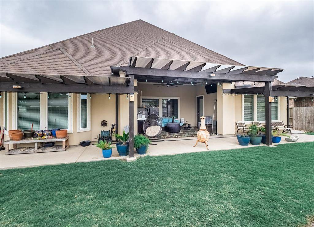the back of the home with the covered patio and the extended patio with Pergola with lexican covering offering additional weather protection