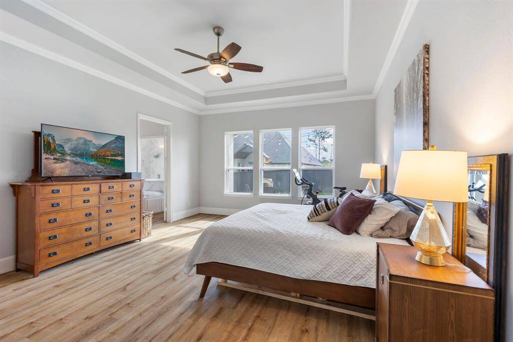 Owner's retreat with high tray ceilings, luxury vinyl plank flooring, and abundant natural light—your tranquil escape after a long day.