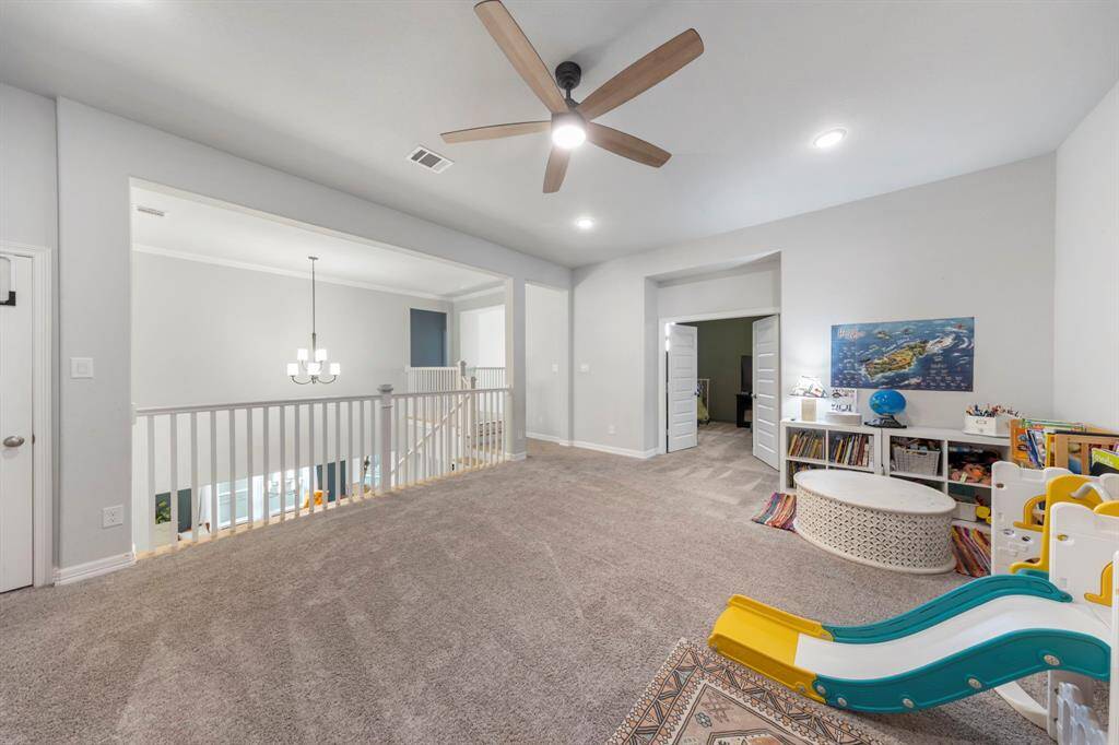 Spacious game room on the second floor offers plenty of room for play or customization. Overlooking the entry and dining areas, with easy access to the media room—perfect for all your entertainment needs!