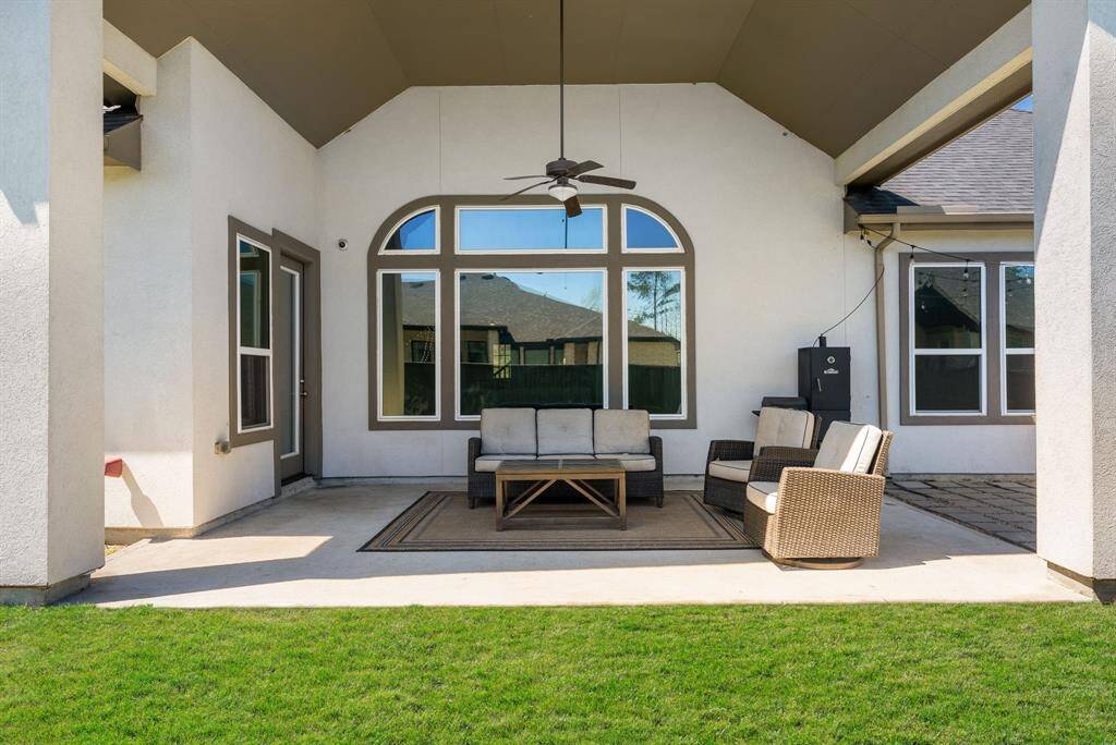 Soaring covered patio with views of the serene backyard.