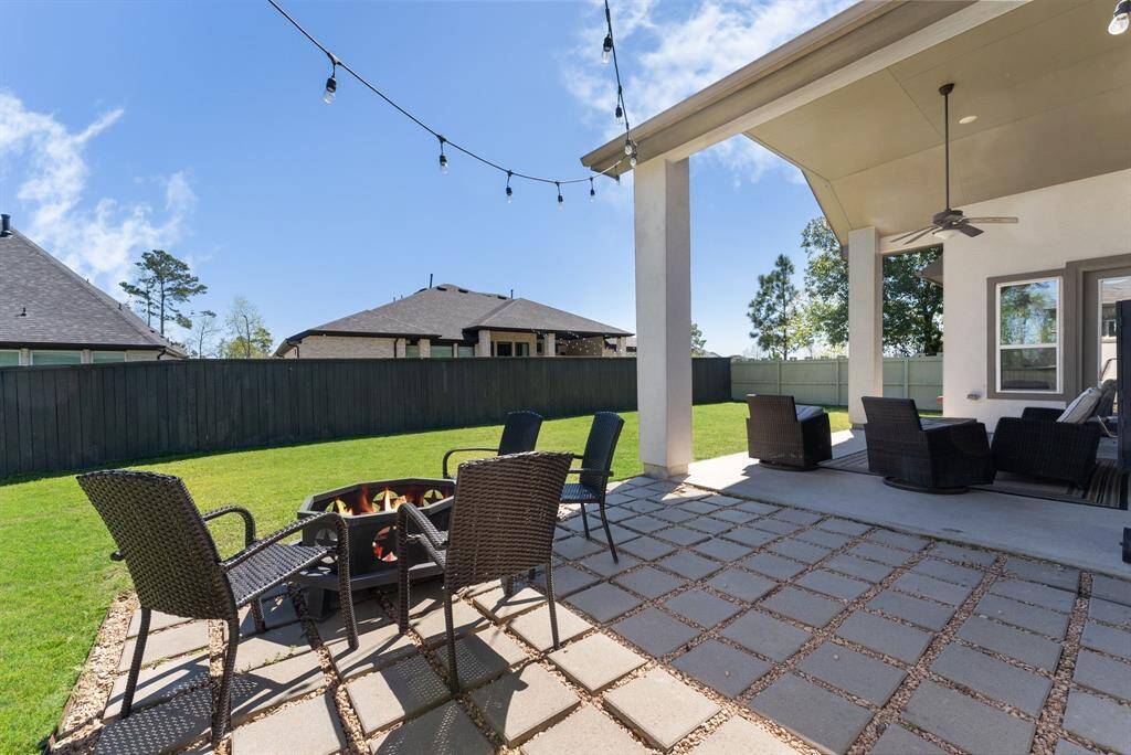 Pavers extended from the covered patio offer an ideal space for outdoor entertaining.