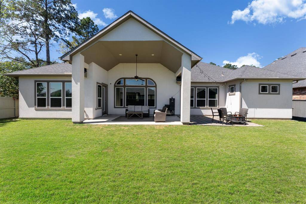 Impressive stucco exterior with A-frame design and a soaring covered back patio, perfect for enjoying the outdoors.