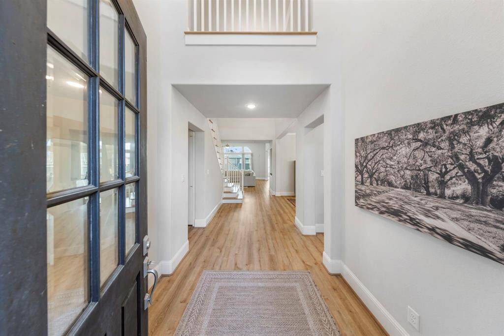 Grand entrance showcases soaring two-story ceilings and stunning luxury vinyl plank flooring.