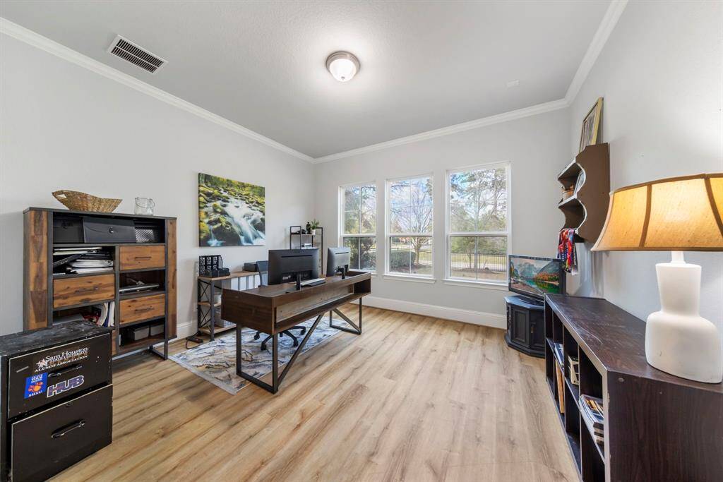 Spacious home office offers abundant natural light, elegant flooring, and a beautiful view—perfect for working from home.