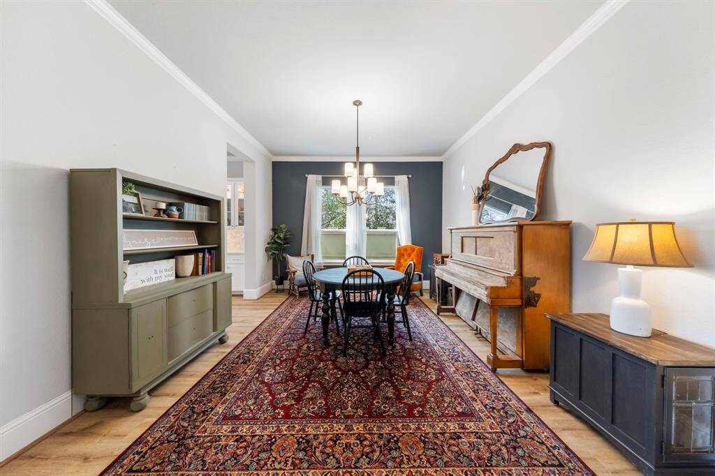 Formal dining boasts elegant crown molding, a stylish accent wall, and plenty of space for entertaining and holiday gatherings.