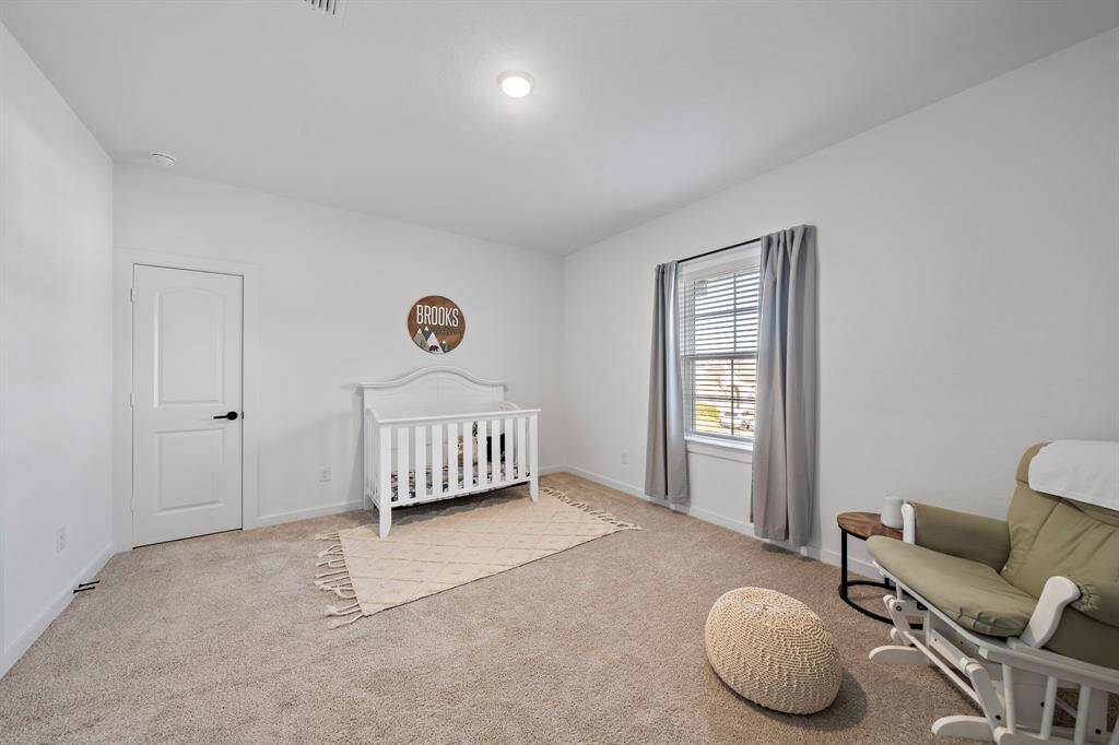 This inviting bedroom is filled with natural light that effortlessly brightens the space. The soothing neutral tones set a serene ambiance, while the thoughtful layout offers plenty of room for furniture and personal touches to make it uniquely yours.