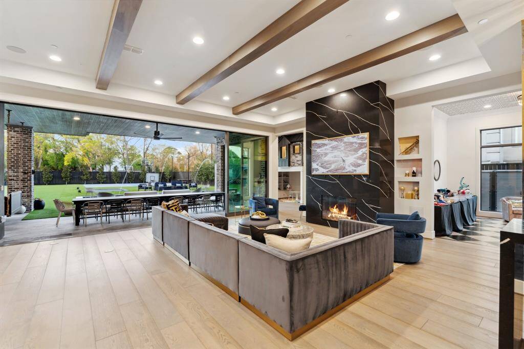 Living room with full open doors heading into the paradise backyard.