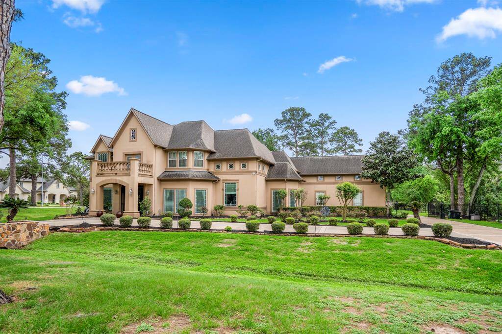 This beautiful estate home has a gorgeous stucco and stone elevation, a covered front arched porch with beautiful custom lighting.
