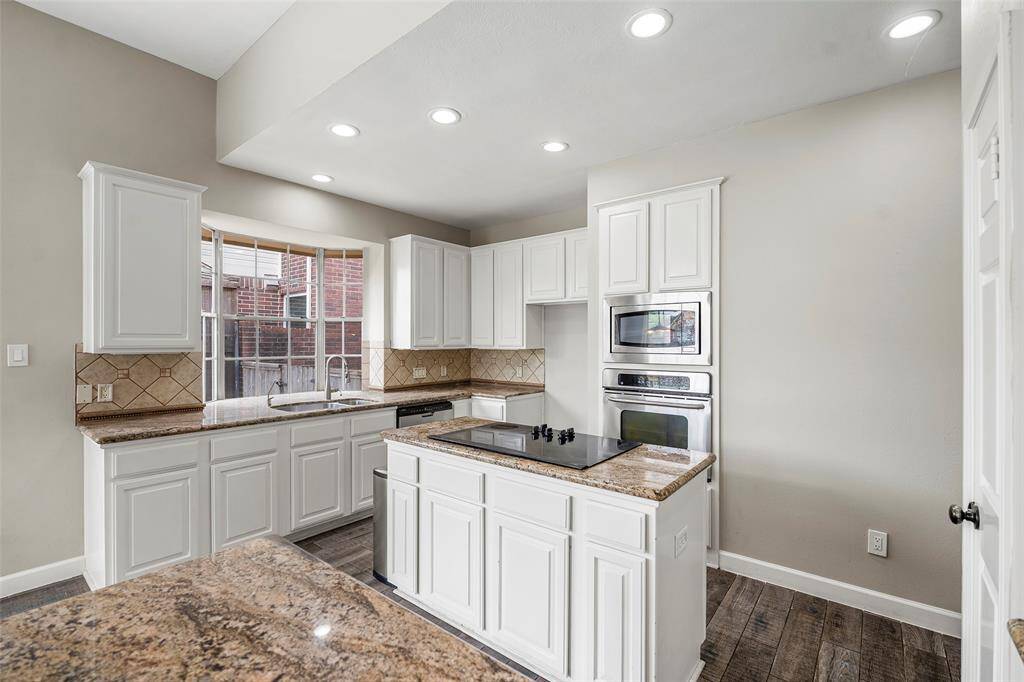 The kitchen island features an electric cooktop with plenty of space to prepare the evening meals.