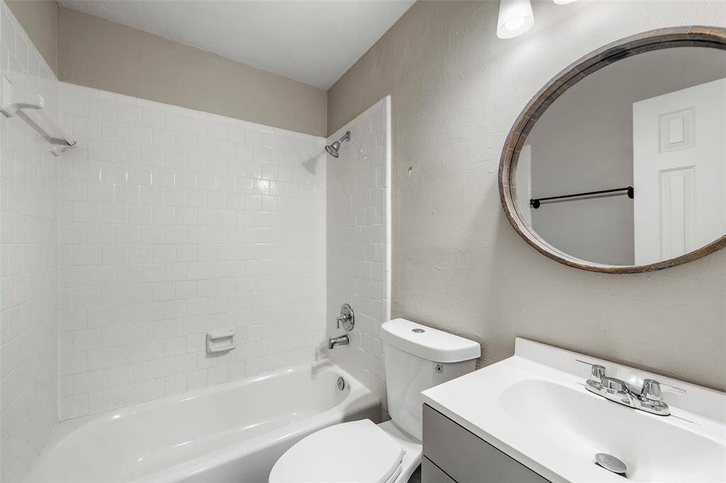 A secondary bath completed with shower/tub combination with tile surround is right outside the downstairs secondary bedroom, making it a perfect in-law suite!
