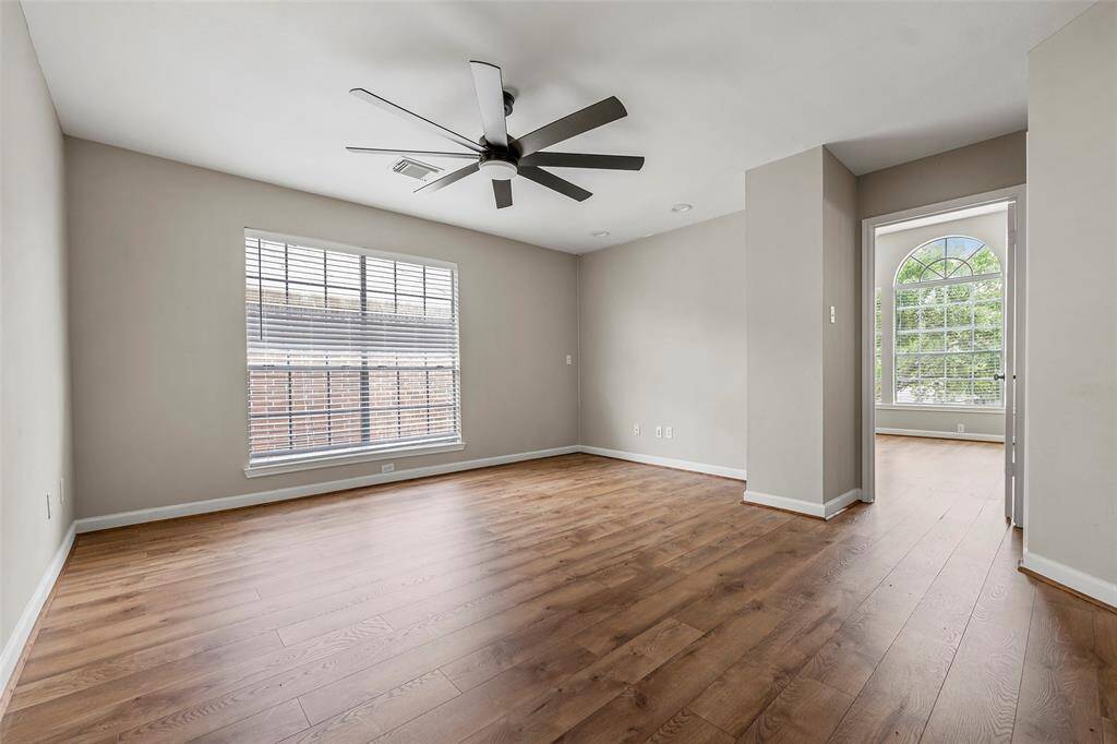 The large window of the secondary bedroom adds so much natural light into this game room!  It could easily be used as a music room, yoga studio, or play room!