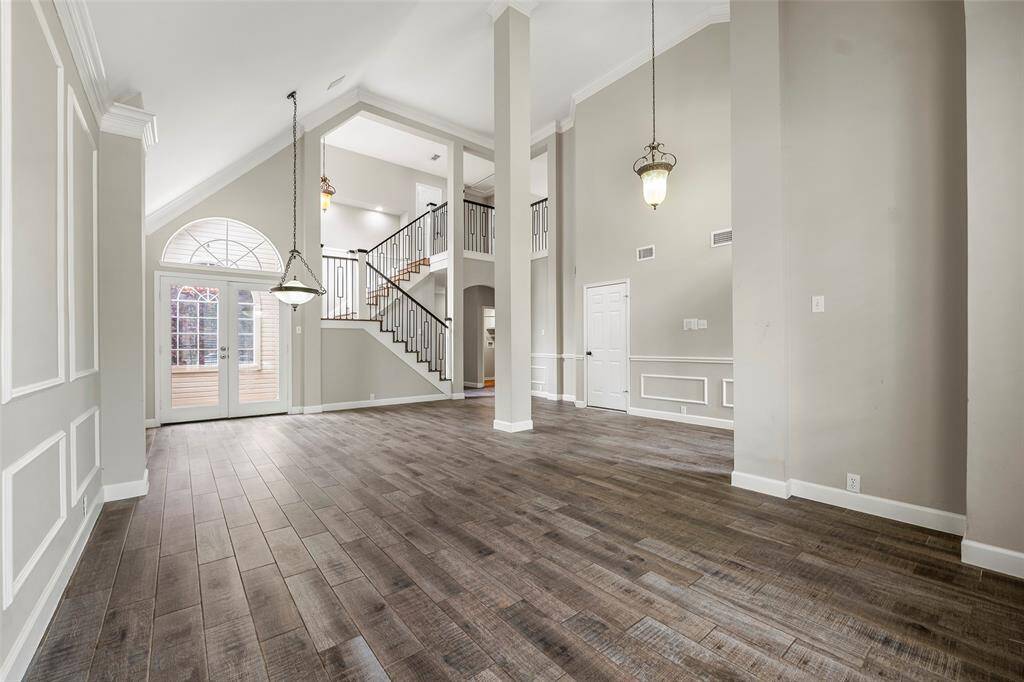 A beautiful formal space is anchored by a stunning chandelier and has double doors that open to the outdoor living areas!