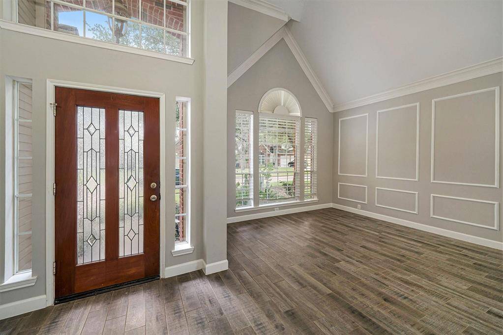 Natural light flows into the space through the leaded glass door, sidelight windows, above picture window and others in the formal living space!