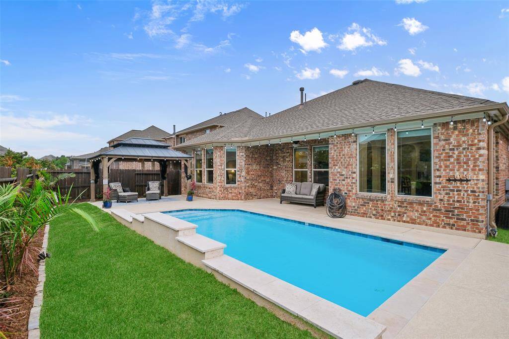 Surrounding the pool is a beautifully landscaped yard with full sprinklers, weed barriers, and easy-care greenery—designed to impress without the stress.