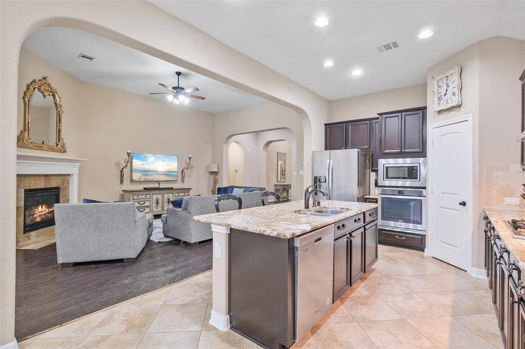 Whether you’re hosting or just making tacos on a Tuesday, the flow from kitchen to living room is seamless. Entertain effortlessly and enjoy the perks of updated Moen bronze kitchen fixtures and PEX plumbing.