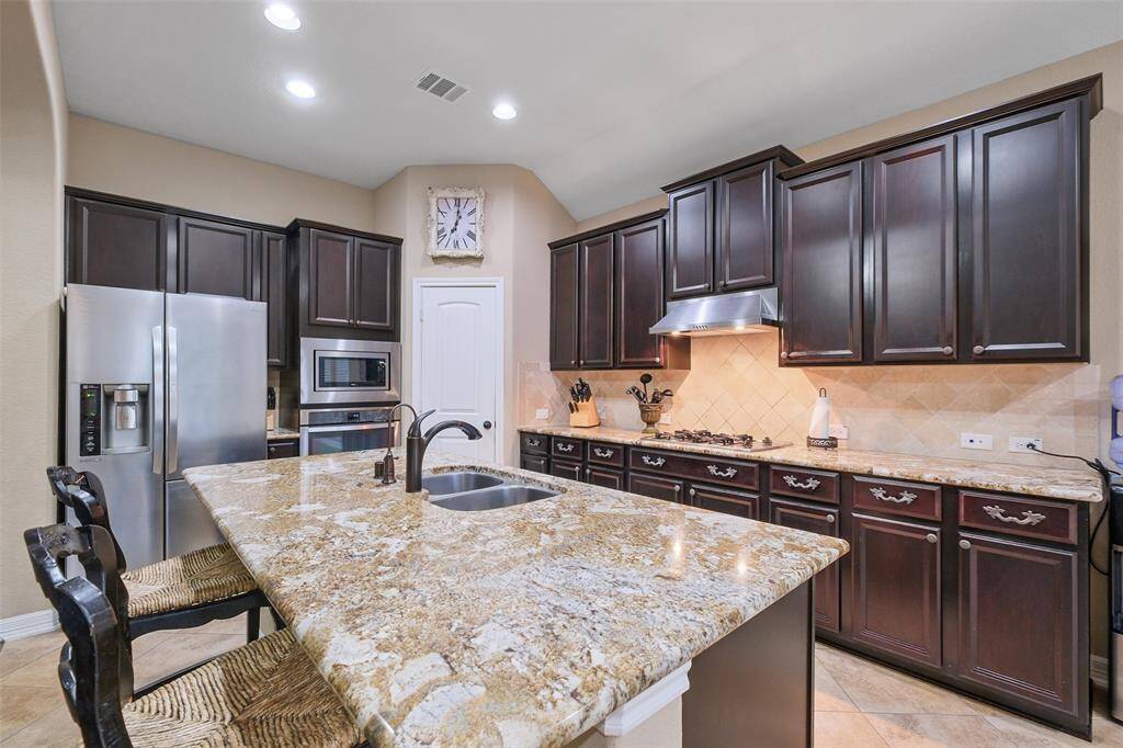This kitchen has it all—counter space for days, upgraded fixtures, and water filtration system under the kitchen sink that ensure clean water for your cooking and family wellness.