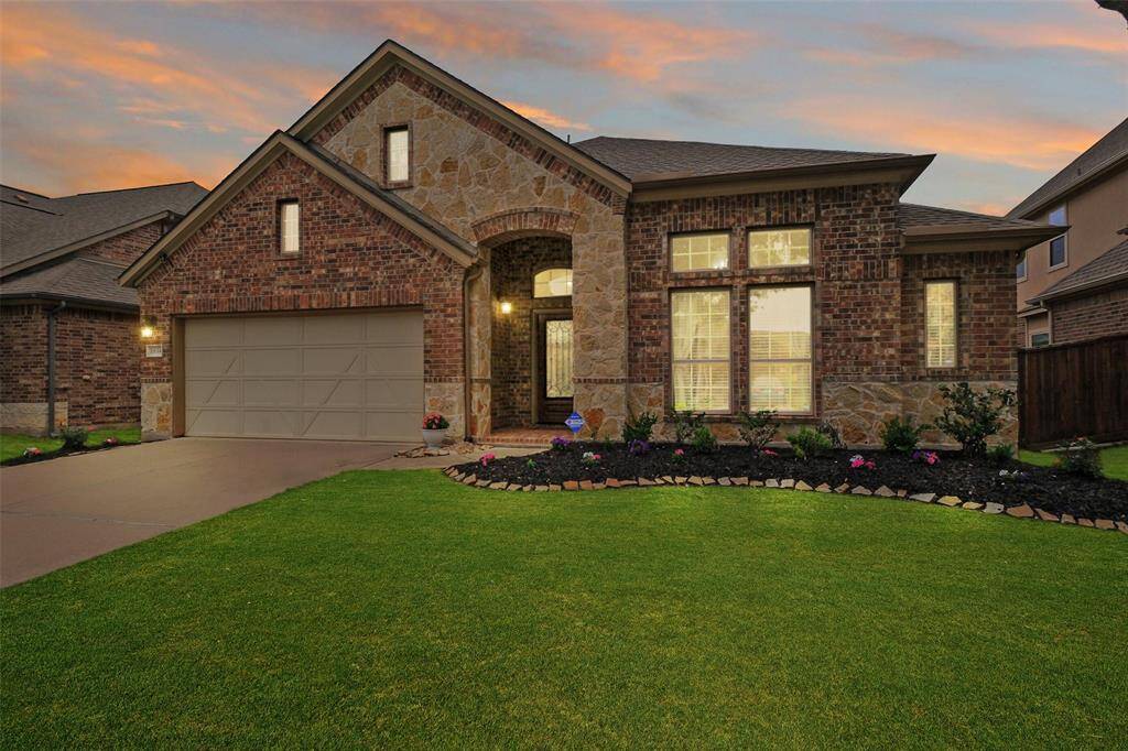 Welcome to 11614 Via Verdone Drive in the desirable Lakes of Bella Terra! This beautifully maintained one-story home boasts classic curb appeal, glowing under a dreamy Texas sunset.
