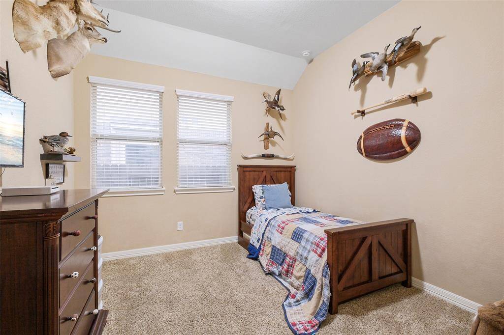 Located just off the formal dining room at the heart of the home, this flexible space features high ceilings, plush carpeting, and charming custom details. Whether used as a cozy bedroom, a guest retreat, or your dream home office, it’s ready to adapt to your lifestyle.