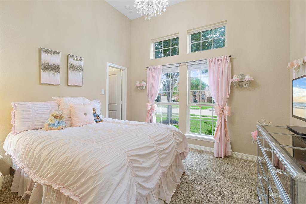 High ceilings and oversized windows give this sweet bedroom a whimsical, airy vibe. Dressed in soft pinks, it’s every little dreamer’s favorite space.