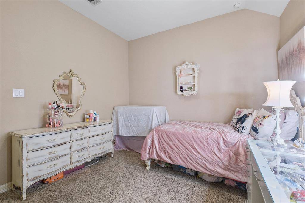 Another view of this bedroom which blends elegance and comfort. A lovely option for a guest room, teen suite, or even a stylish home office—flexibility meets flair in this cozy space.