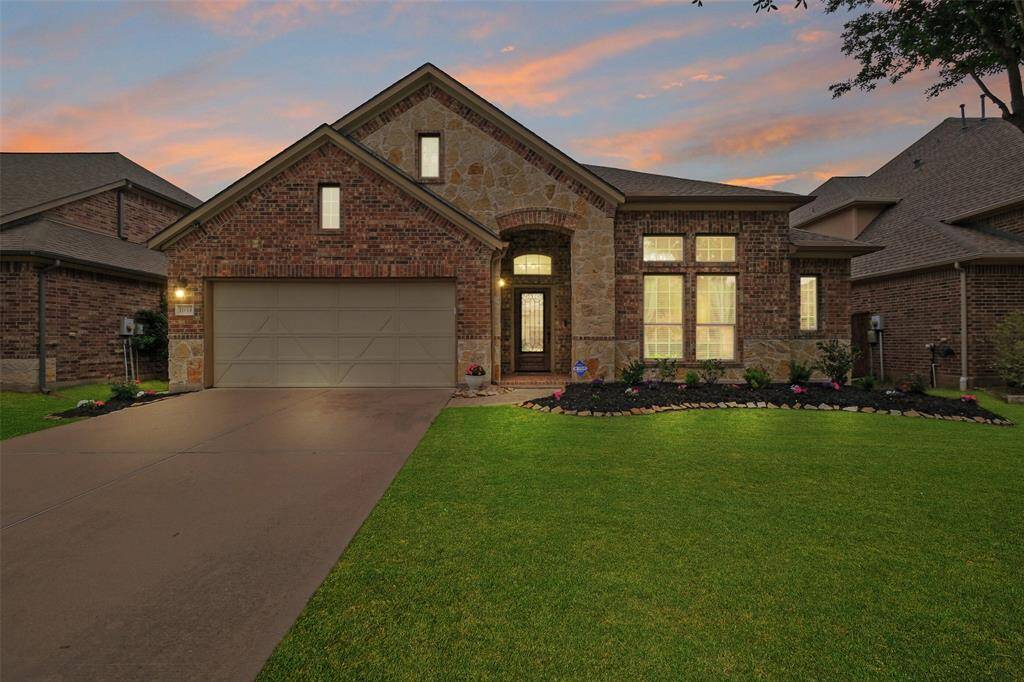 Evening perfection. The warm brick and stone façade paired with soft exterior lighting makes this 4-bedroom, 2-bathroom beauty shine—inside and out.