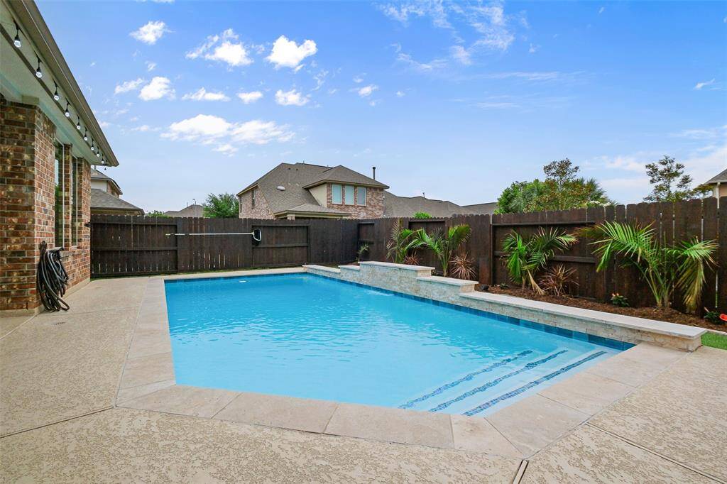 Dive into luxury with a stunning 15,000-gallon in-ground pool featuring waterfall accents and a sparkling color-changing pool light—perfect for both sun-drenched afternoons and evening swims under the stars.