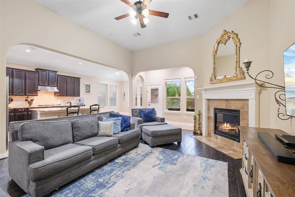 Gather around the cozy gas fireplace in this open-concept living area. The soaring ceilings and large windows bring in natural light, while AC coils (2023) and a new AC fan (2024) keep things cool and efficient year-round.