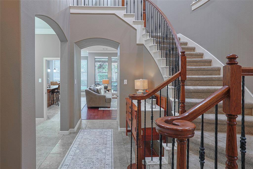 Welcome home! Note the grand staircase with wrought iron railing