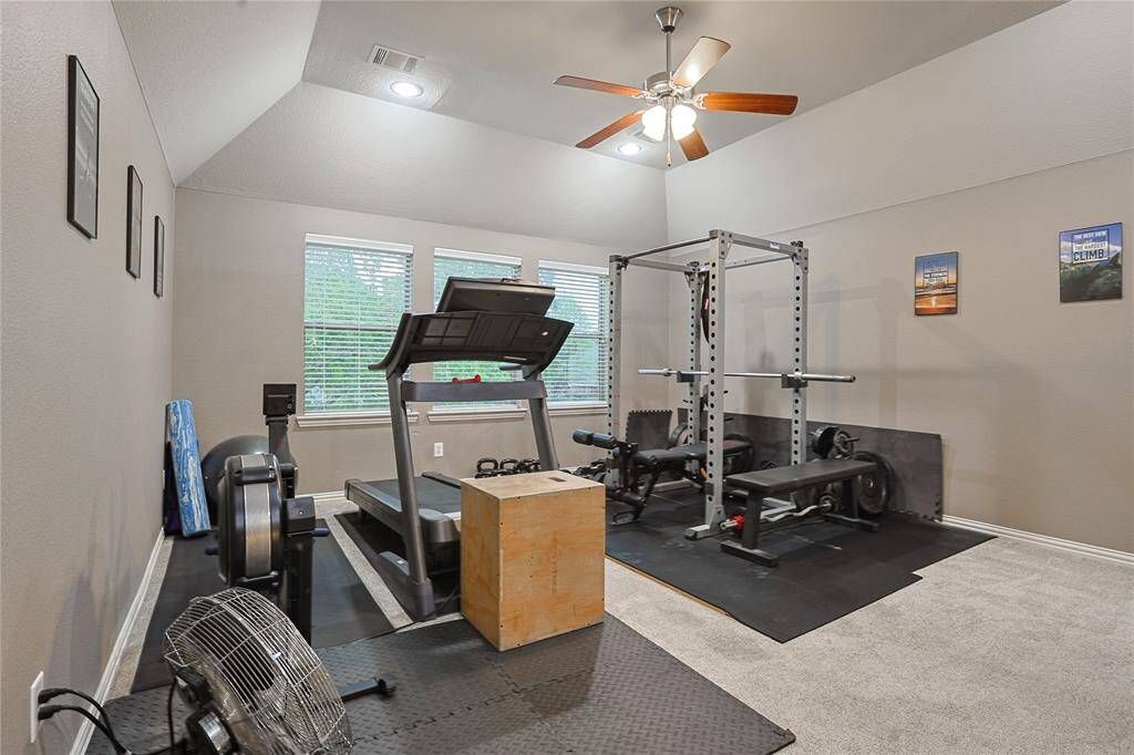 Large game room/secondary den is being used as a home gym
