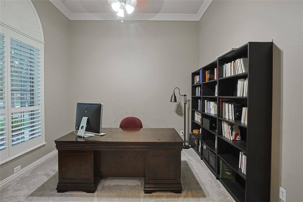 Situated immediately to your left when entering the home is the study with crown molding, shutters and french doors