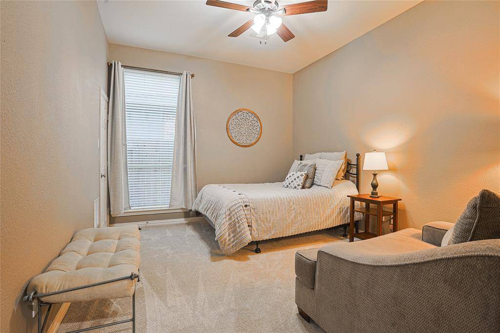 Take a right when entering the home and you will venture into the secondary bedroom located on the main floor. Plenty of room for a small seating area. Perfect for a comfortable guest suite.