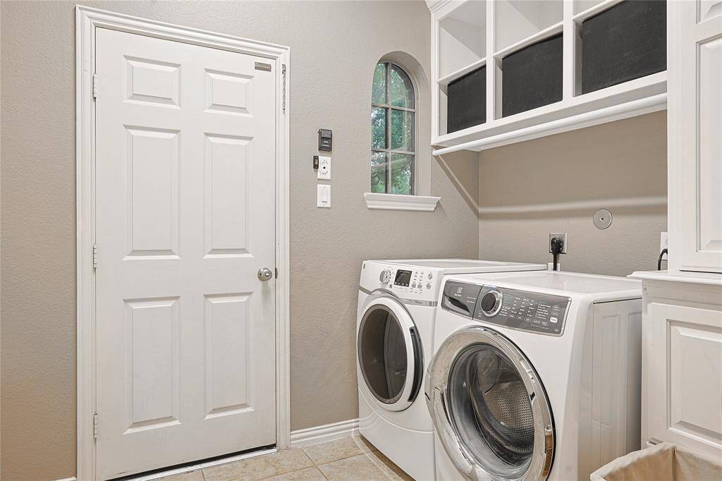 Wow! Large laundry room with storage above and on the facing wall. Located as you walk in from two car garage making it the PERFECT drop zone