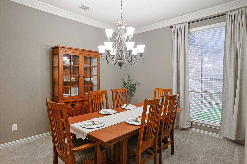 Dining room with crown molding. Dining room not your thing? Could easily be utilized as another den/living space