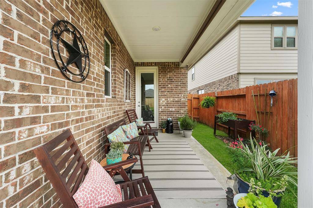 Charming covered side patio perfect for morning coffee or a quiet reading spot.