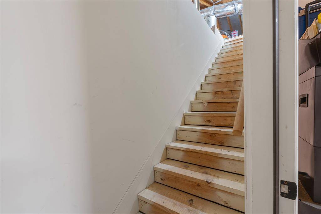 Stairs lead to walk-in attic storage.