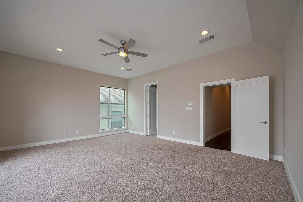At the top of the stairs on the 2nd floor, you'll find the owner's suite, featuring a 10-ft ceiling, ceiling fan, and recessed lighting for a bright, airy feel. Soft, warm carpet adds comfort to the space, as it does throughout the bedrooms. For added peace of mind, the home is equipped with an alarm system, ensuring both comfort and security.