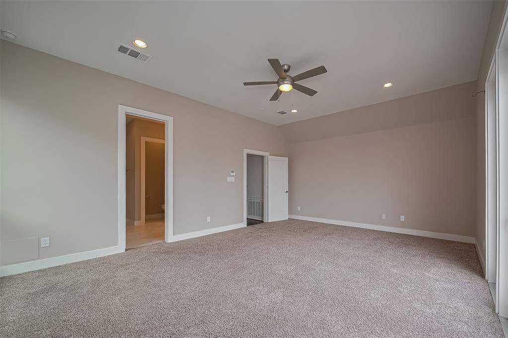 The owner's suite is a spacious retreat (20.3 x 15.3), offering plenty of wall space for furniture arrangement and personalization. A door on the left leads to the luxurious owner's ensuite bath, while a set of windows and full light door opens to a private balcony, providing an outdoor space to relax and unwind.