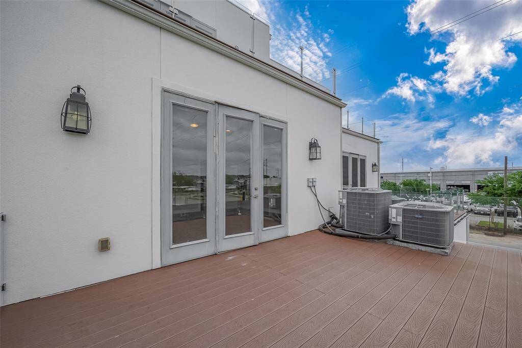 A full-light door opens to a spacious balcony, where coach lights on each side provide gentle illumination for nighttime enjoyment. The durable composite decking material ensures a low-maintenance space, perfect for unwinding at the end of the day. The home is equipped with zoned high-efficiency HVAC systems, optimizing comfort on each floor year-round. Gutters along the exterior efficiently direct water away from the residence, contributing to the home's functionality and upkeep.