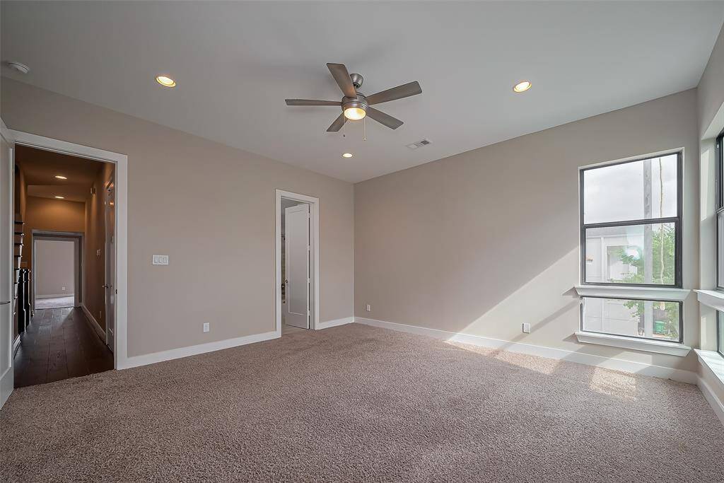 At the opposite end of the hallway is Bedroom #2, which could easily serve as a second owner's suite. It features its own private ensuite bathroom for added convenience and privacy. The room also includes a ceiling fan and recessed lighting, ensuring both comfort and modern style.