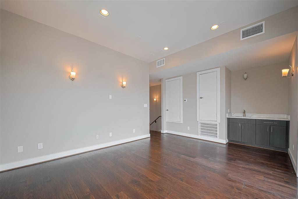 The gameroom, measuring 16.7 x 12.8, offers plenty of space for a sofa and a big-screen TV, making it perfect for relaxation and entertainment. A wet bar with a quartz countertop along one wall adds a touch of convenience and style, creating an ideal setup for hosting friends and family. Whether for movie nights or casual gatherings, this versatile space is designed for both comfort and fun.