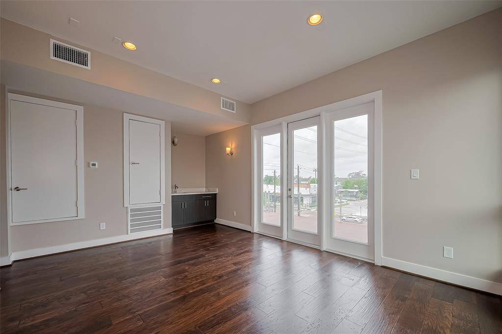 The gameroom's large windows and full-light door open to the home's second balcony, offering a fantastic way to extend your living space outdoors. Whether for relaxing or entertaining, this balcony provides a perfect spot to enjoy fresh air and views, seamlessly blending indoor and outdoor living.