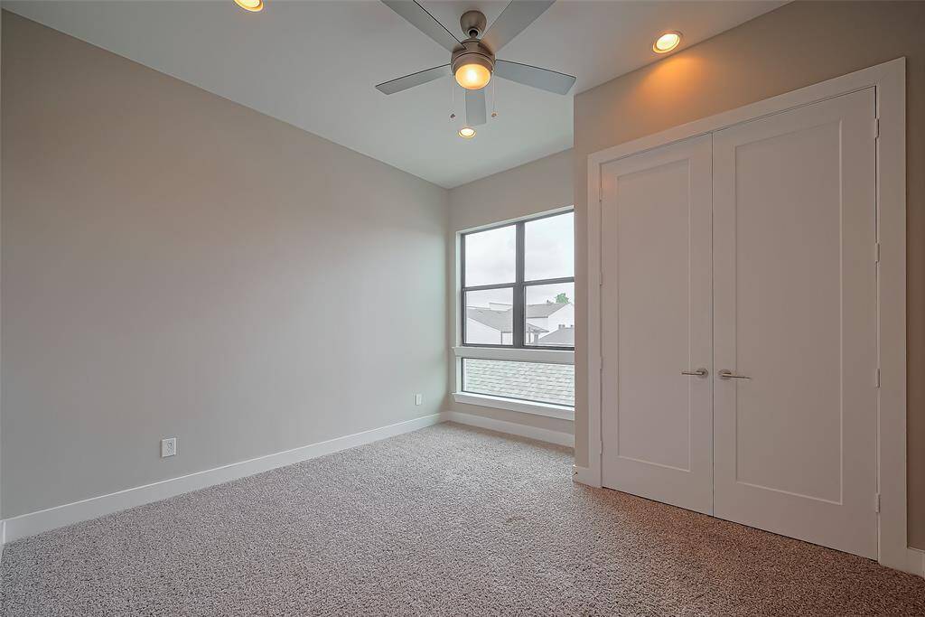 Bedroom #3 features a large window overlooking the sideyard, allowing for plenty of natural light. A double-door closet provides ample storage space, ensuring the room is both functional and stylish.