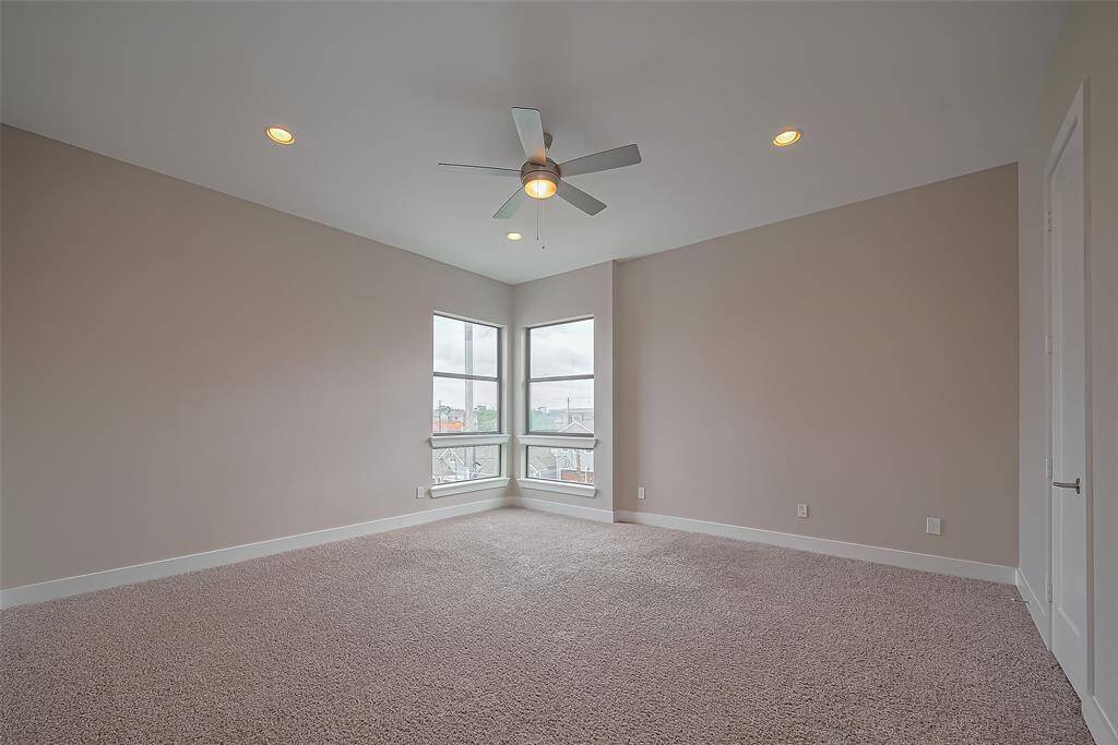 Bedroom #4 features a pair of corner windows that overlook Laird, offering great views and plenty of natural light. The room provides ample wall space, making it easy to arrange furniture to suit your needs. Built in 2017, this home includes modern energy-efficient features, such as double-pane Low-E windows throughout, enhancing both comfort and energy savings.