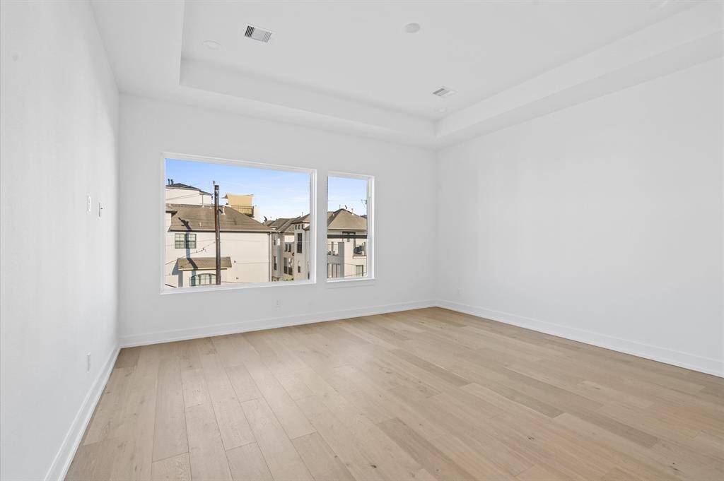 Spacious primary bedroom with Downtown views.