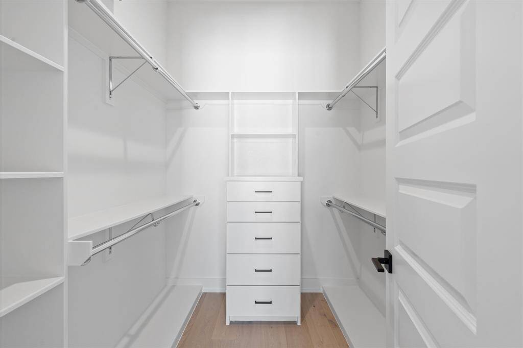 Primary closet features cabinetry