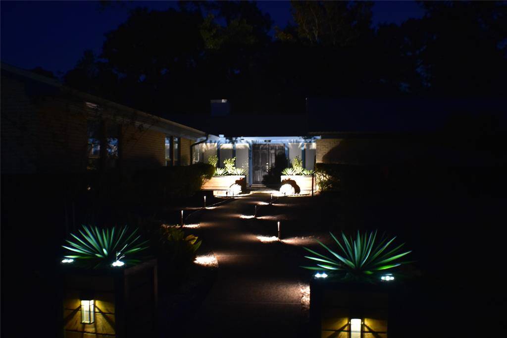 Automatic wired lights on the walkway and front porch with solar at the planters.